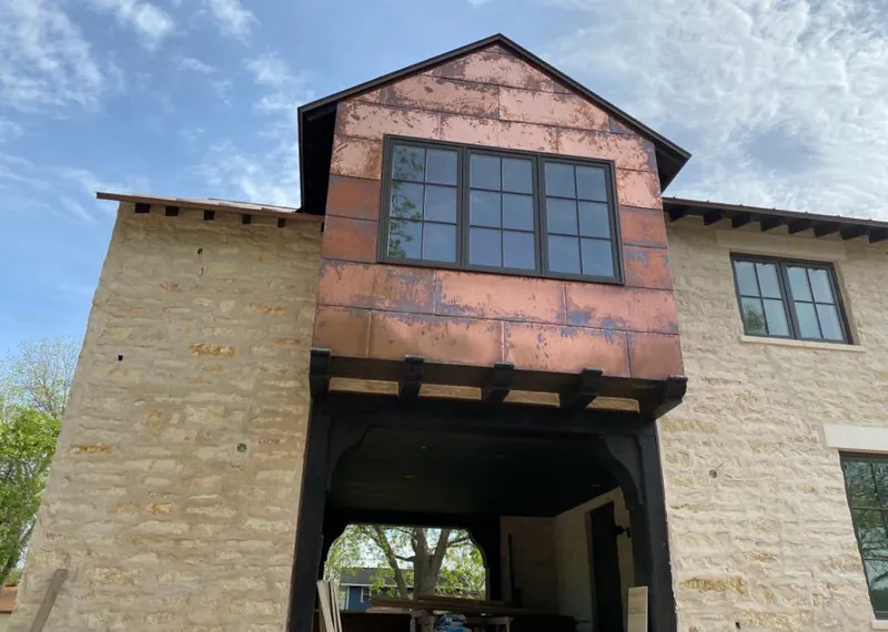 Copper metal panel facade on a stone building for Skylight Installation in Mint Hill